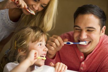 family brushing their teeth